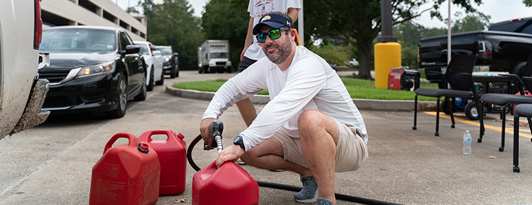 Chris Adams, Vice President of Government Relations, pumping gas for co-workers in need after Hurricane Ida.